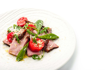 Smoked ham and arugula salad on the white background