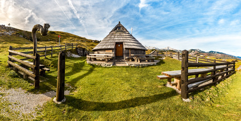 Fototapeta na wymiar Mountain cottage hut or house on idyllic hill Velika Planina.