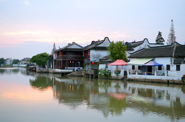 Old village by river in Shanghai with boat..