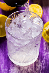 Glass of ice cubes on the wooden background