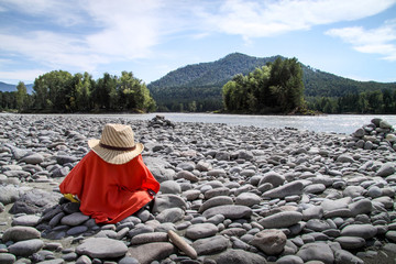 Tourist undressed on the bank of mountain river