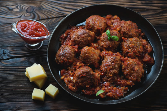 Meatballs with tomato sauce and parmesan cheese, studio shot
