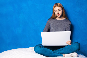 Cute girl against blue wall