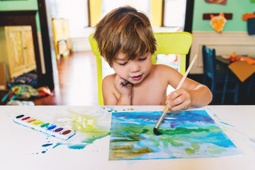 Boy painting with watercolors