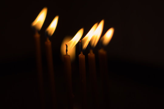 Close-up of candles burning