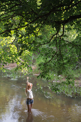 Fototapeta premium girl standing in the river