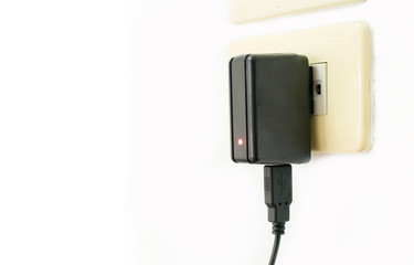Mobile phone charger on electric outlet