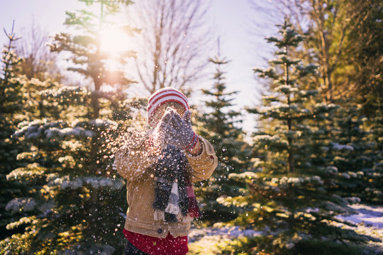 Boy Brushing Snow Off His Gloves