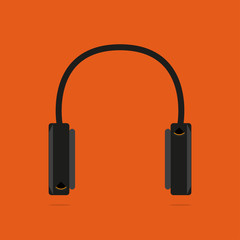 Headphones on an orange background. With shadow