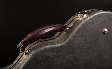 Grey leather case for mandolin on black background. - obrazy, fototapety, plakaty