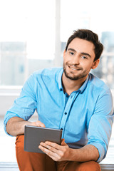Young businessman in office with window