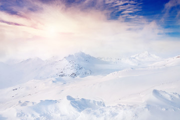 Beautiful winter landscape with snow-covered mountains at sunset