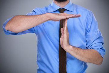 Man showing time out gesture
