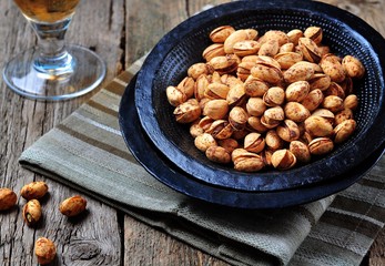 Pistachio flavored barbecue in a black plate on a wooden background