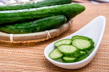 sliced green cucumber in white plate