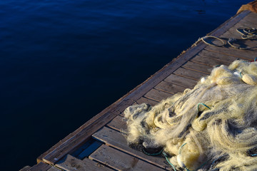 Fishing net on a wooden pier and sea