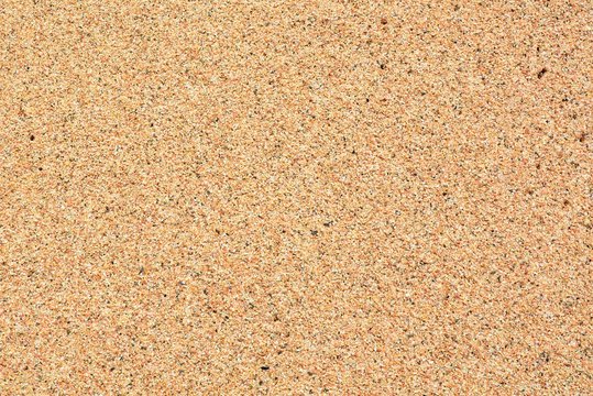 Dark brown background or texture from the sand on the beach.