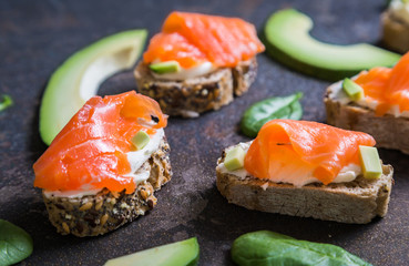 Mini sandwiches with smoked salmon avocado and spinach
