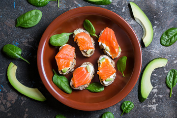 Mini sandwiches with smoked salmon avocado and spinach