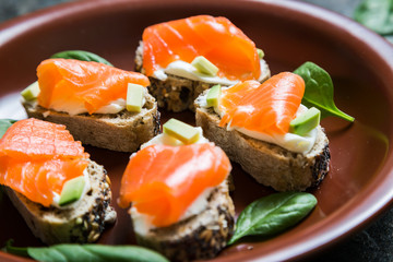 Mini sandwiches with smoked salmon avocado and spinach