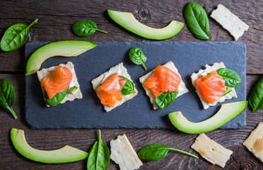 Crackers with cream cheese smoked salmon and avocado