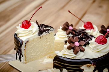 Birthday cake, vanilla Chocolate Cherry was divided pieces on a