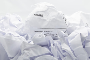 Resume crumpled up and thrown away in the trash.