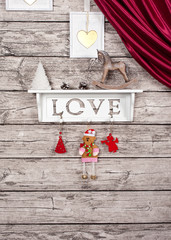 Decorative hinged shelf with the inscription love with toys on the wall