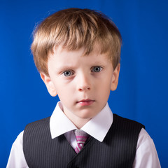 Portrait of the boy of the blonde with blue eyes