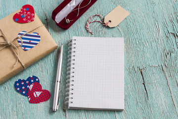 Valentine's day gift in kraft paper, women's jewelry chain in velvet pouch and clean  blank notepad...