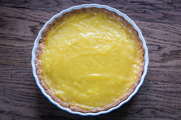 Lemon tart on the wooden background