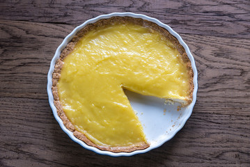 Lemon tart on the wooden background