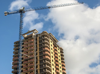 New high-rise building on the background of the cloudy sky