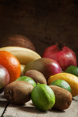 Tropical fruits: coconut, kiwi, lime, orange, mango, bananas, po