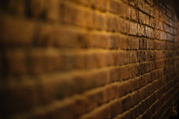 Angle view of old red brick wall o interior with shallow DOF - obrazy, fototapety, plakaty