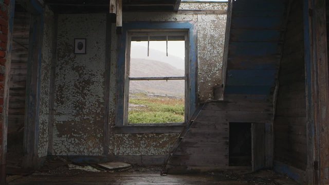Interior of an abandoned building in Hebron, Newfoundland and Labrador on a snowy day. Slow Motion