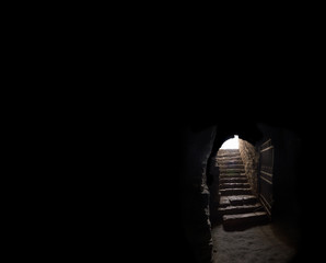 Stone hallway with upward staircase