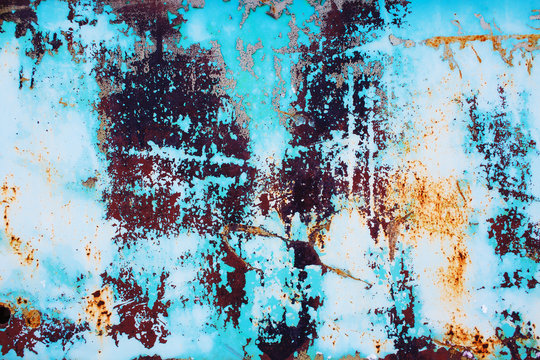 rusty metal with cracked blue paint. colored background of rusty iron surface with a bright blue paint peeling and cracking texture
