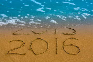 Happy New Year 2016 replace 2015 concept on the sea beach
