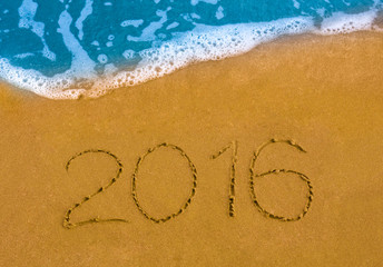 Happy New Year 2016 on the sea beach.