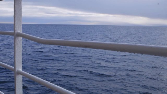Ocean view through the railing of an arctic cruise ship. Slow Motion