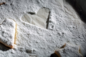 Homemade cookies with powdered sugar on a baking tray bakery