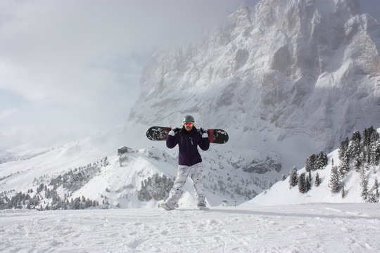Snowboard girl. Young woman take her snowboard.
