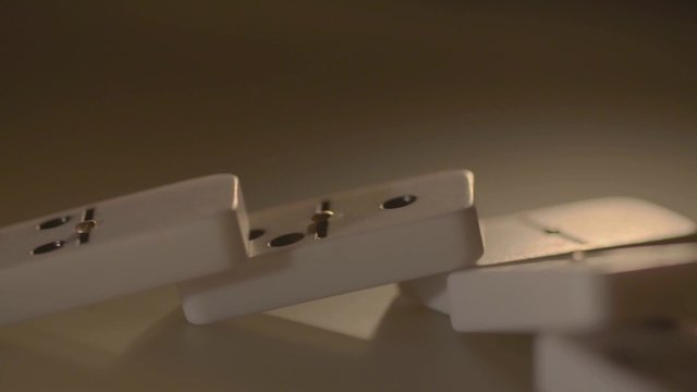 Human Hands Play with White Domino at Table