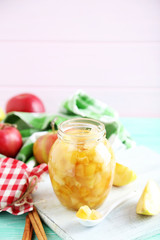 Apple jam in jar on a mint wooden table