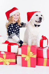 Girl and white dog are sitting with gifts