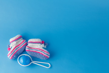 Rattle and knitted booties for the newborn