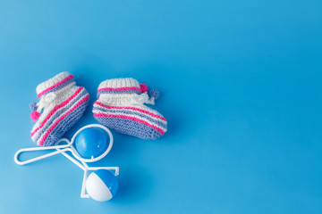 Rattle and knitted booties for the newborn