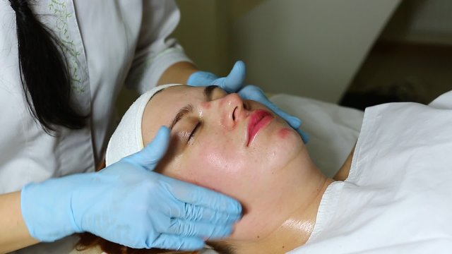 woman passes treatment mask facial at the beauty salon