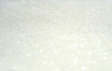 Blurred holiday background with white glitter sparkles like a snow